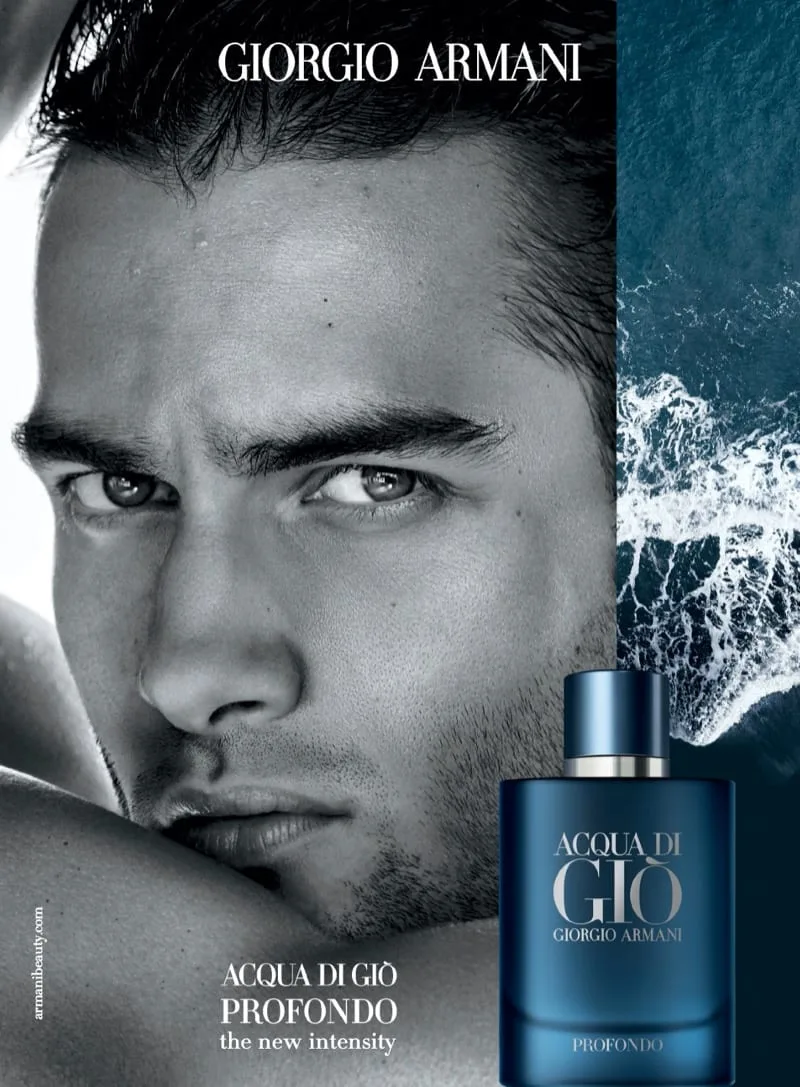 The official press advertisement: Aleksandar Rusić's face in monochrome close-up beside a ribbon of deep teal surf, the gradient-blue Profondo flacon below