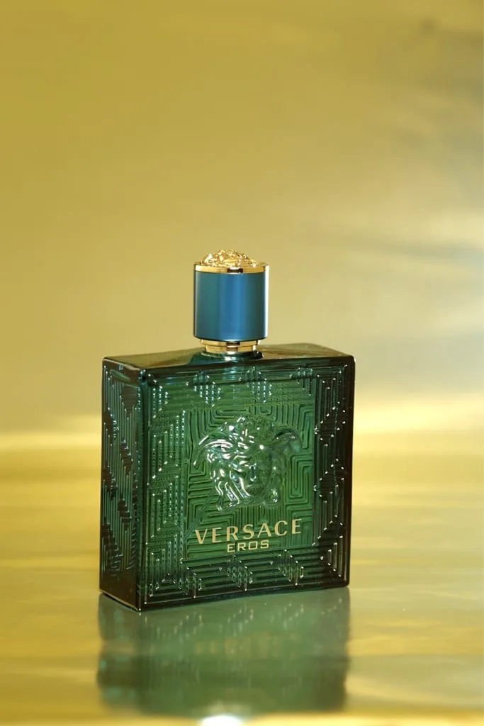 The deep sea-green flacon alone, cut with the Greca labyrinth and the Medusa in relief, standing on a molten gold ground